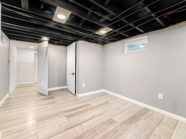 basement with wood finished floors and baseboards