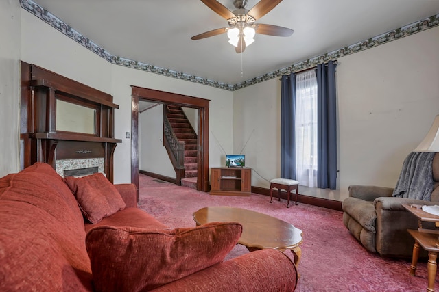 222 Union St, Lancaster, OH 43130 - living area with carpet flooring, stairs, a tiled fireplace, ceiling fan, and baseboards