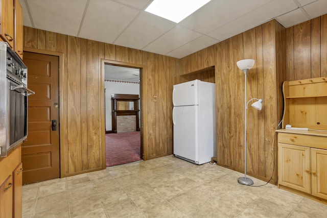222 Union St, Lancaster, OH 43130 - kitchen with freestanding refrigerator, wooden walls, and black oven