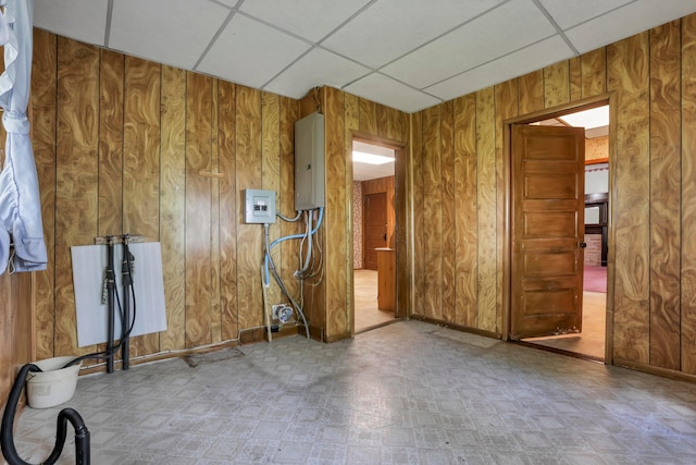 222 Union St, Lancaster, OH 43130 - empty room with a drop ceiling, electric panel, wood walls, and tile patterned floors