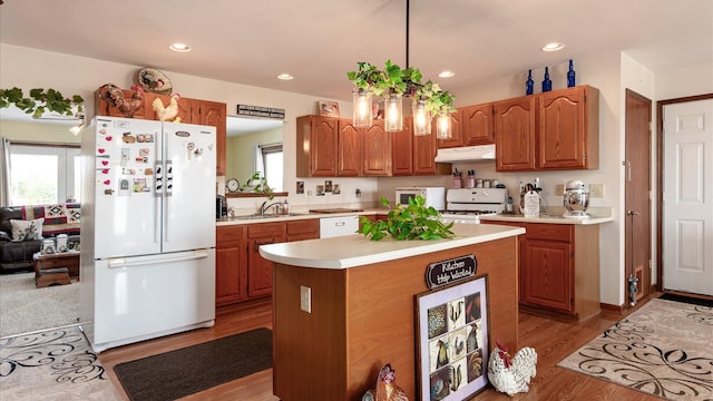 3890 Township Road 70 NW, Somerset, OH 43783 - kitchen with white appliances, under cabinet range hood, a sink, light countertops, and a kitchen island