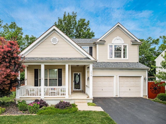 299 Stonhope Dr, Delaware, OH 43015 - traditional-style house with covered porch, driveway, a garage, and a shingled roof
