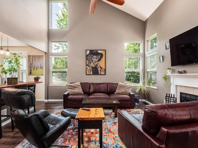 299 Stonhope Dr, Delaware, OH 43015 - living area with high vaulted ceiling, dark wood-style floors, a tiled fireplace, and a ceiling fan