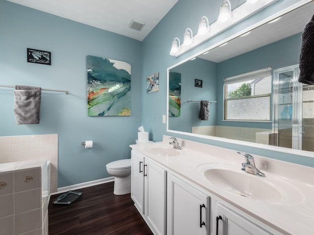 299 Stonhope Dr, Delaware, OH 43015 - bathroom with wood finished floors, double vanity, a garden tub, and a stall shower