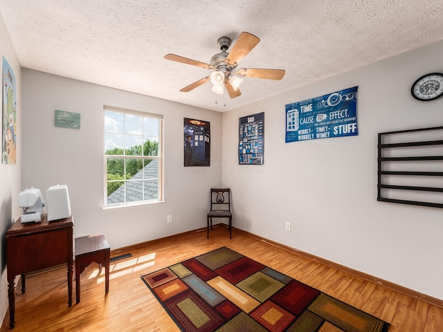 299 Stonhope Dr, Delaware, OH 43015 - living area with wood finished floors, a textured ceiling, and ceiling fan