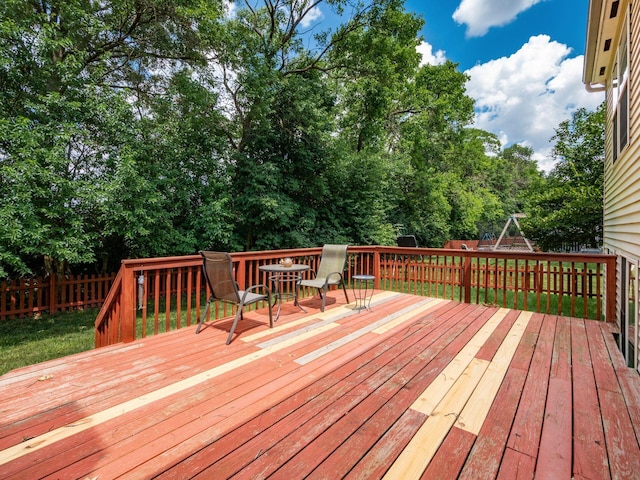 299 Stonhope Dr, Delaware, OH 43015 - wooden deck featuring a fenced backyard, view of wooded area, and outdoor dining space