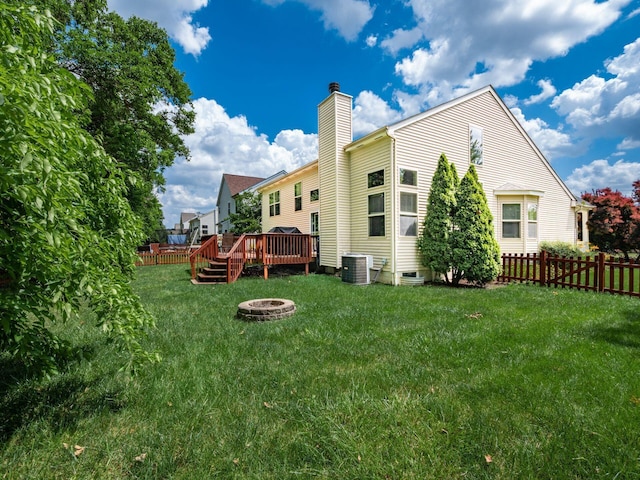 299 Stonhope Dr, Delaware, OH 43015 - back of property with an outdoor fire pit, a chimney, and a wooden deck
