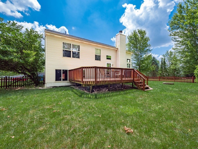 299 Stonhope Dr, Delaware, OH 43015 - back of property with a fenced backyard, a deck, and a chimney