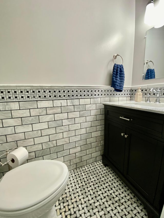 299 Stonhope Dr, Delaware, OH 43015 - half bath featuring tile walls, vanity, and a wainscoted wall