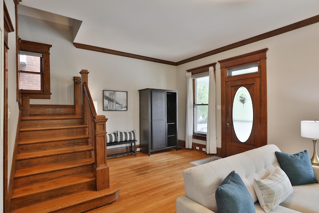 459 E Whittier St, Columbus, OH 43206 - living room featuring crown molding, stairs, and light wood-style flooring