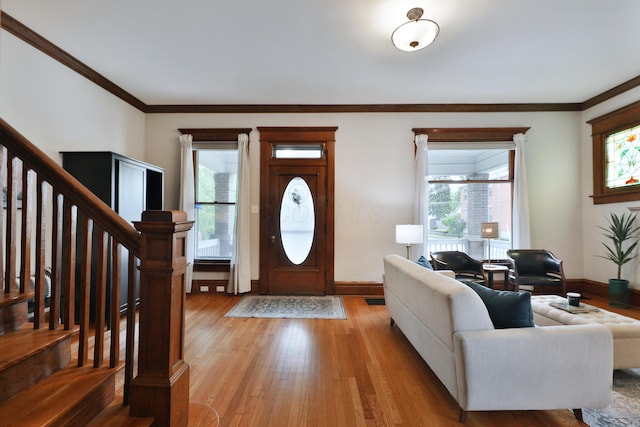 459 E Whittier St, Columbus, OH 43206 - foyer entrance featuring healthy amount of natural light, stairs, light wood finished floors, and ornamental molding