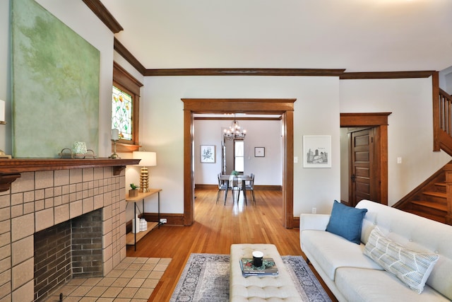 459 E Whittier St, Columbus, OH 43206 - living area featuring stairway, ornamental molding, a chandelier, light wood finished floors, and baseboards
