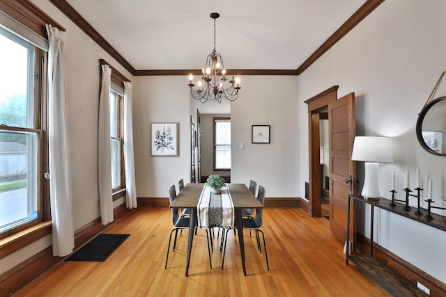 459 E Whittier St, Columbus, OH 43206 - dining space with crown molding, a chandelier, light wood-type flooring, and baseboards