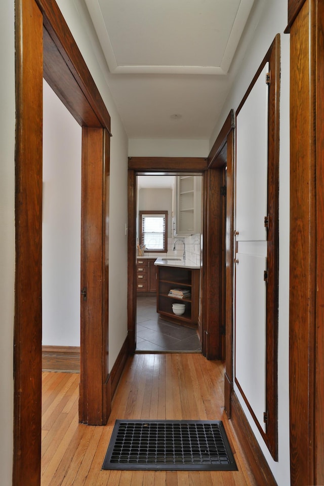 459 E Whittier St, Columbus, OH 43206 - hallway with light wood-style floors, a sink, and baseboards
