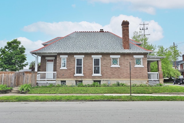 459 E Whittier St, Columbus, OH 43206 - view of home's exterior featuring a chimney, covered porch, and a shingled roof