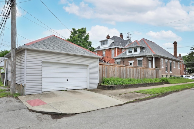 459 E Whittier St, Columbus, OH 43206 - view of front facade featuring a detached garage, fence, a shingled roof, and an outdoor structure