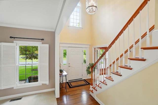 6467 Spring Run Dr, Westerville, OH 43082 - entryway featuring a chandelier, a high ceiling, stairway, baseboards, and crown molding