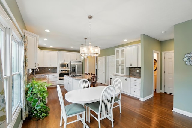 6467 Spring Run Dr, Westerville, OH 43082 - dining area featuring dark wood-style floors, recessed lighting, baseboards, and a chandelier