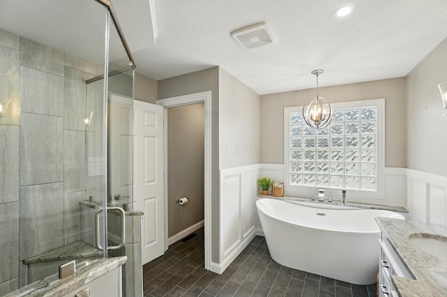 6467 Spring Run Dr, Westerville, OH 43082 - full bath featuring a stall shower, a freestanding bath, wainscoting, vanity, and a decorative wall