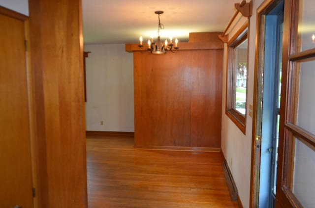 494 Park Overlook Dr, Worthington, OH 43085 - unfurnished dining area featuring a chandelier, wood finished floors, a baseboard radiator, and baseboards