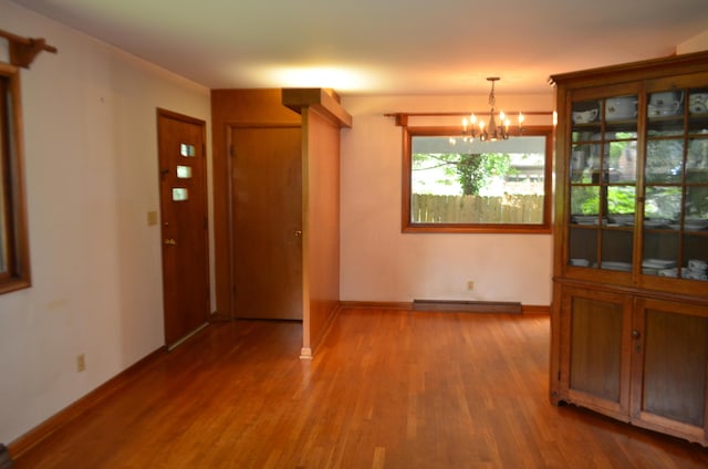 494 Park Overlook Dr, Worthington, OH 43085 - unfurnished dining area with a chandelier, wood finished floors, and baseboards