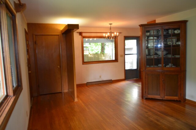 494 Park Overlook Dr, Worthington, OH 43085 - unfurnished dining area featuring a chandelier, wood finished floors, baseboard heating, and baseboards