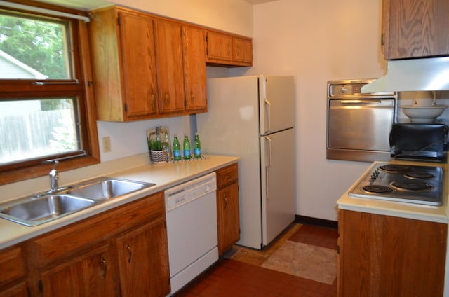 494 Park Overlook Dr, Worthington, OH 43085 - kitchen with stainless steel appliances, a sink, under cabinet range hood, brown cabinetry, and light countertops