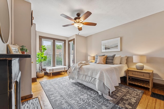 1057 Harrison Ave, Columbus, OH 43201 - bedroom featuring wood finished floors, ceiling fan, and a textured ceiling