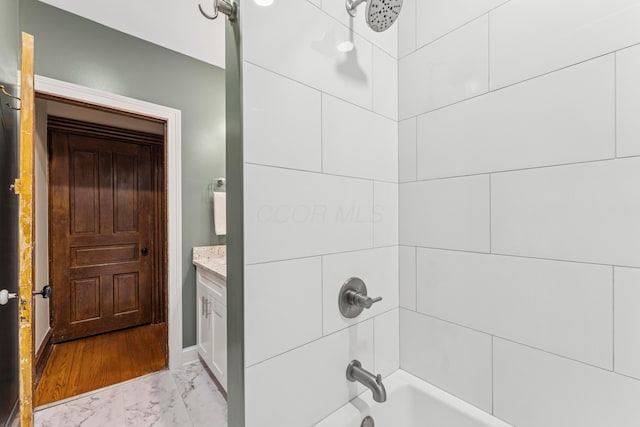 1057 Harrison Ave, Columbus, OH 43201 - bathroom featuring marble finish floors, washtub / shower combination, and vanity