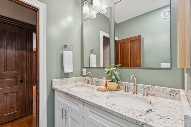1057 Harrison Ave, Columbus, OH 43201 - bathroom featuring double vanity and wood finished floors