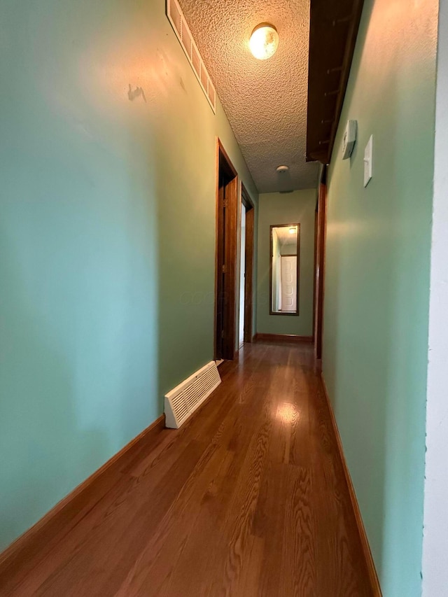 2836 Palisades Ave, Columbus, OH 43207 - hallway with a textured ceiling and wood finished floors