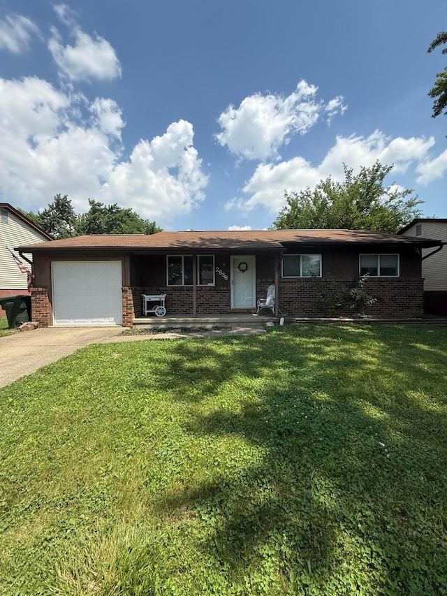 2836 Palisades Ave, Columbus, OH 43207 - view of front of house featuring brick siding, an attached garage, driveway, and a front yard