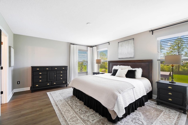 bedroom with wood finished floors and baseboards
