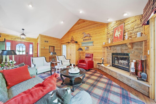 7326 State Route 19 Unit 3, Lots 1-2, Mount Gilead, OH 43338 - living room with wood walls, vaulted ceiling, a stone fireplace, and wood finished floors