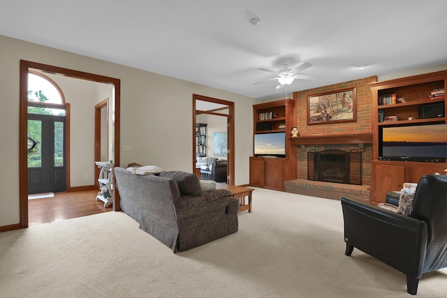 7832 Windsor Ave NW, Canal Winchester, OH 43110 - living room featuring carpet, a brick fireplace, ceiling fan, and baseboards