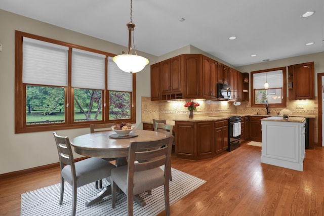 7832 Windsor Ave NW, Canal Winchester, OH 43110 - kitchen with black appliances, plenty of natural light, light wood finished floors, tasteful backsplash, and recessed lighting
