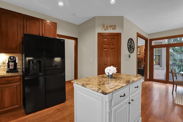 7832 Windsor Ave NW, Canal Winchester, OH 43110 - kitchen with black fridge with ice dispenser, light wood-style floors, light stone countertops, white cabinetry, and recessed lighting
