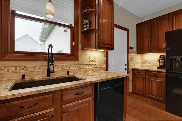 7832 Windsor Ave NW, Canal Winchester, OH 43110 - kitchen featuring black appliances, a sink, decorative backsplash, and light stone counters
