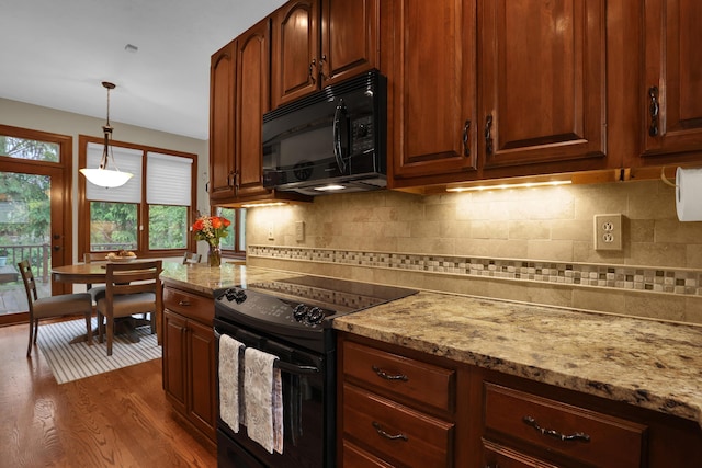 7832 Windsor Ave NW, Canal Winchester, OH 43110 - kitchen with black appliances, dark wood finished floors, light stone countertops, decorative light fixtures, and decorative backsplash