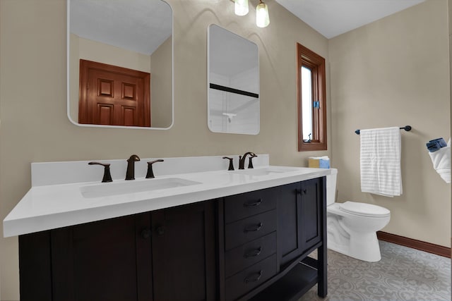 7832 Windsor Ave NW, Canal Winchester, OH 43110 - bathroom with toilet, a shower, double vanity, and baseboards