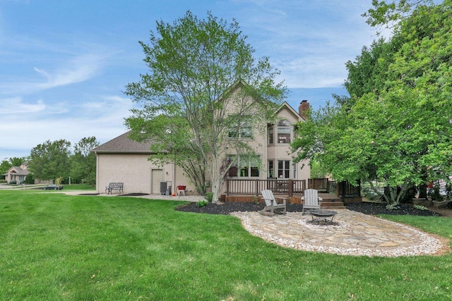 7832 Windsor Ave NW, Canal Winchester, OH 43110 - back of property with a fire pit, stucco siding, a lawn, and a patio
