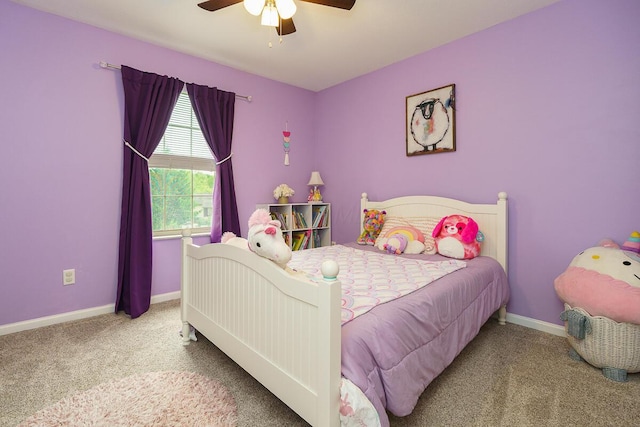 carpeted bedroom with baseboards and a ceiling fan