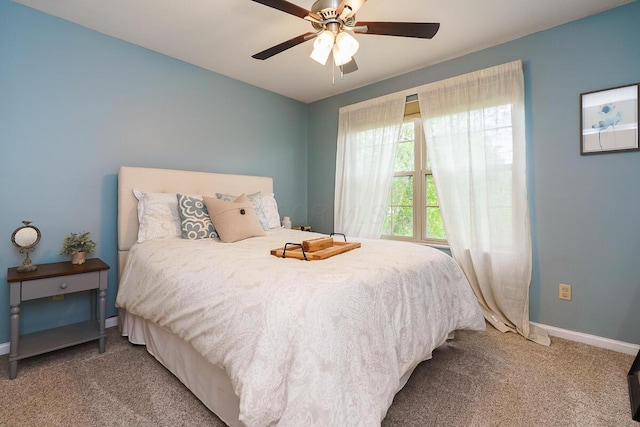 carpeted bedroom with baseboards and a ceiling fan