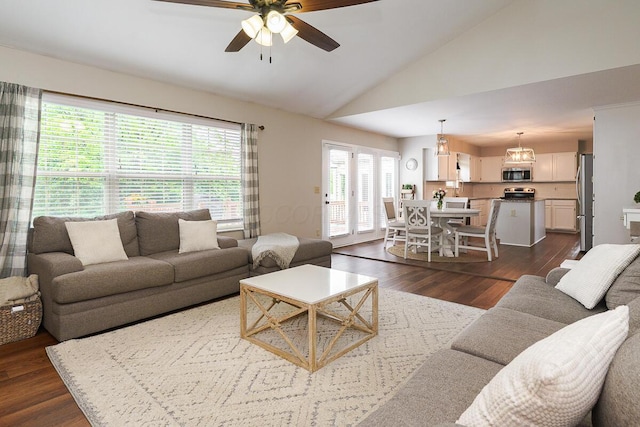 living room with lofted ceiling, ceiling fan, and dark wood-style flooring