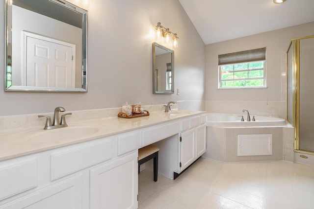 bathroom with a bath, double vanity, a shower stall, and lofted ceiling