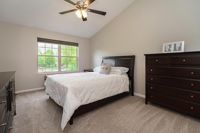 bedroom featuring light carpet, baseboards, ceiling fan, and high vaulted ceiling