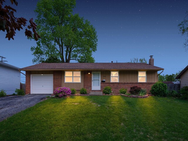5030 Holbrook Dr, Columbus, OH 43232 - ranch-style house with an attached garage, brick siding, a chimney, board and batten siding, and a front lawn