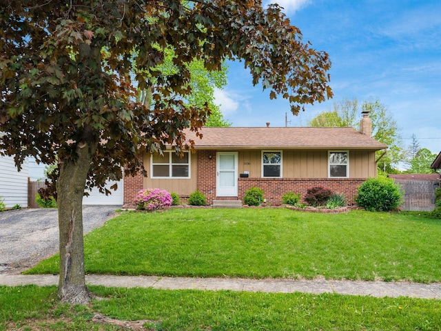 5030 Holbrook Dr, Columbus, OH 43232 - ranch-style home featuring a chimney, brick siding, driveway, and an attached garage