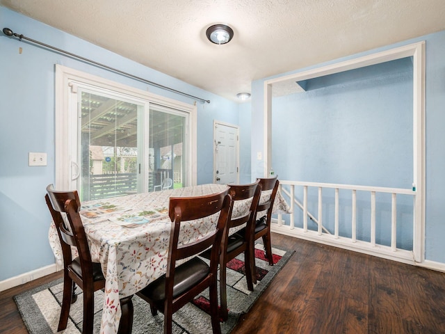 5030 Holbrook Dr, Columbus, OH 43232 - dining room featuring dark wood-type flooring, baseboards, and a textured ceiling