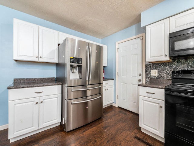 5030 Holbrook Dr, Columbus, OH 43232 - kitchen with black appliances, dark countertops, dark wood-style flooring, white cabinets, and decorative backsplash